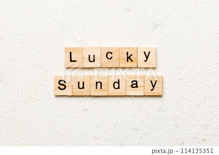 lucky sunday word written on wood block. lucky sunday text on cement table for your desing, concept 114135351