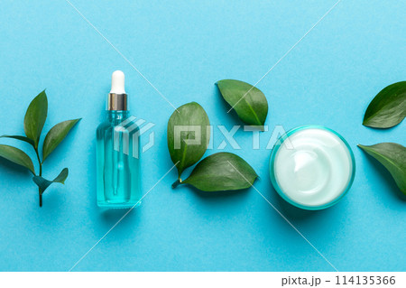 Organic cosmetic products with green leaves on color background 114135366