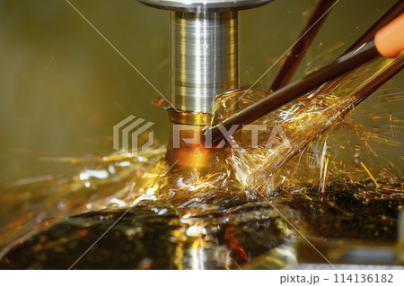 Close up scene the CNC milling machine rough cutting the mold parts with oil coolant method. Close up scene the CNC milling machine rough cutting the mold parts with oil coolant method. 114136182