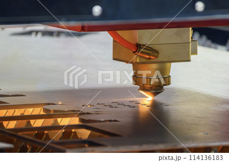 The fiber laser cutting machine  cut the metal plate with the sparkling light. 114136183