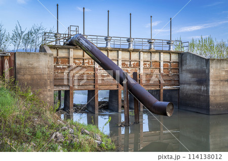 gates and pump station on a channel in a valley of Missouri river near Peru, Nebraska 114138012