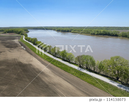 dusty rural road along the Missouri River near WIlton, MO, springtime aerial view 114138073