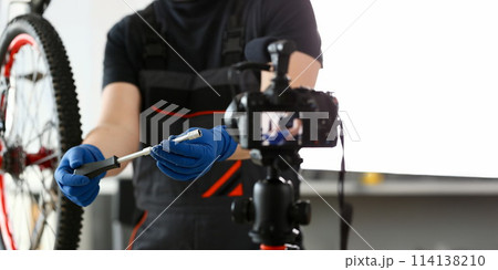 Male blogger hand service man bicycle workshop Male blogger hand service man bicycle workshop 114138210