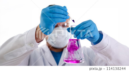 A male chemist holds test tube of glass A male chemist holds test tube of glass 114138244