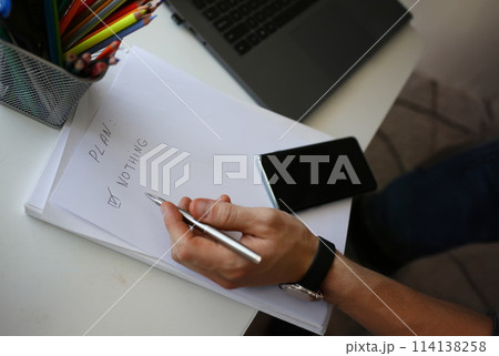 Male hand hold silver pen composing to do list 114138258