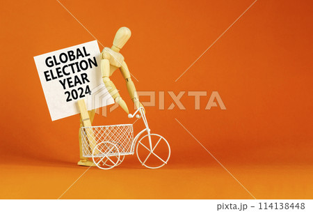 Global election year 2024 symbol. Concept words Global election year 2024 on beautiful white paper on clothespin. Beautiful orange background. Business Global election year 2024 concept. Copy space 114138448