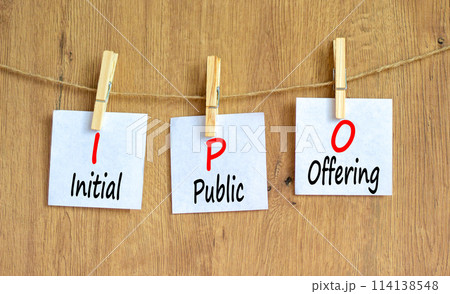 IPO initial public offering symbol. Concept words IPO initial public offering on beautiful white paper. Beautiful wooden background. Business IPO initial public offering concept. Copy space. IPO initial public offering symbol. Concept words IPO initial public offering on beautiful white paper. Beautiful wooden background. Business IPO initial public offering concept. Copy space. 114138548