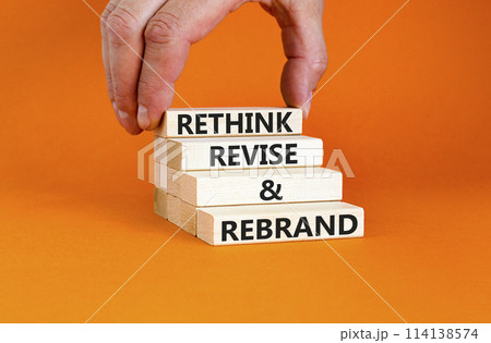 Rethink revise rebrand symbol. Concept word Rethink Revise and Rebrand on beautiful block. Beautiful orange background. Business brand motivational rethink revise rebrand concept. Copy space. 114138574