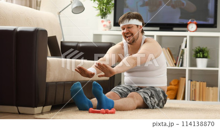 Young attractive fitness man lies on a fat mat with 114138870