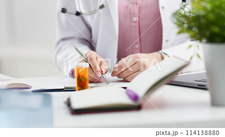 Female medicine doctor hand hold jar of pills Female medicine doctor hand hold jar of pills 114138880