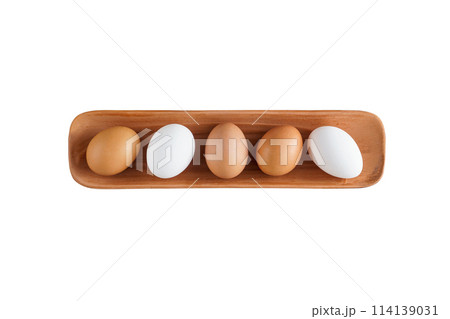 fresh white and brown chicken eggs lie in a clay serving plate fresh white and brown chicken eggs lie in a clay serving plate 114139031