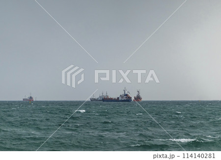 Sea freighter sailing in the middle of the ocean with big waves. Sea freighter sailing in the middle of the ocean with big waves. 114140281
