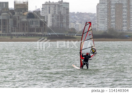 A kite surfer rides and jumps the waves the black sea 114140304