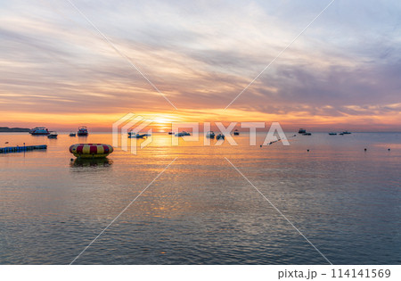 Beautiful red and orange sunrise over the sea. Beautiful red and orange sunrise over the sea. 114141569