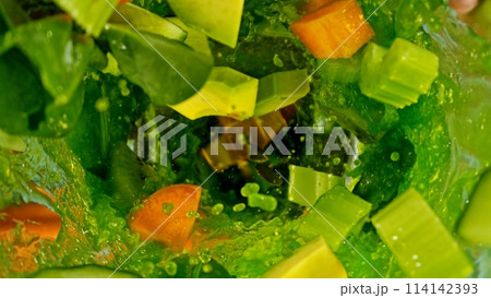 Freeze motion of mixing pieces of fruit and vegetables in blender, top shot Freeze motion of mixing pieces of fruit and vegetables in blender, top shot 114142393