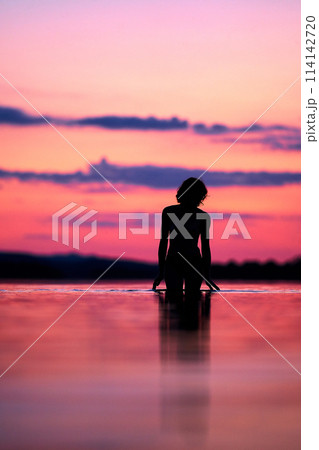 Women silhouette sunset on the lake Women silhouette sunset on the lake 114142720