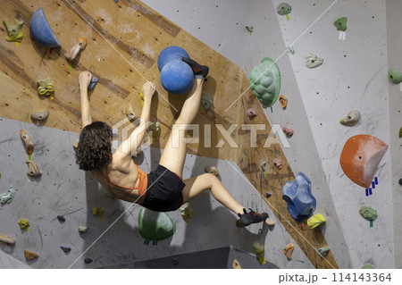 girl climbing up the wall 114143364