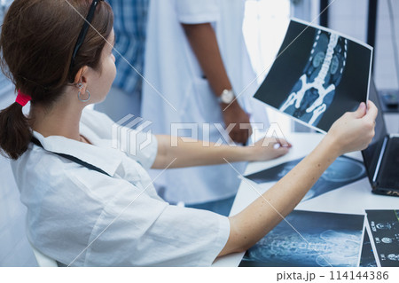 Female medical student study in class room. medical students studying human brain disease diagnosis 114144386