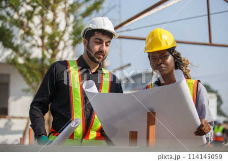 Construction civil engineer man and woman African American checking quality of work 114145059