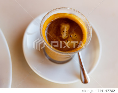 Cup of fresh cortado on table 114147782