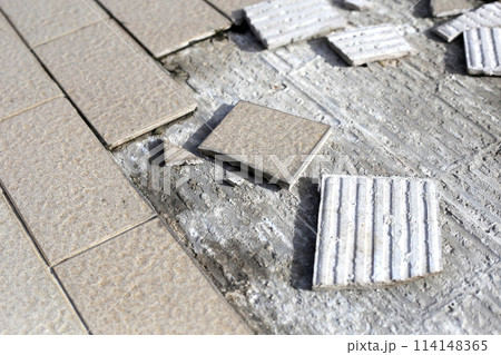 Cracked brown tiles on cement floor Cracked brown tiles on cement floor 114148365