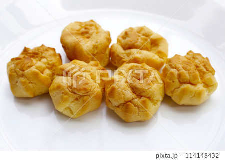 Cream puffs on white background Cream puffs on white background 114148432