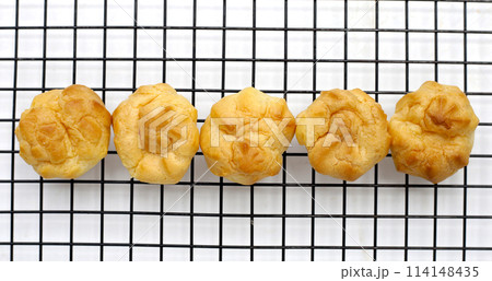 Cream puffs on white background Cream puffs on white background 114148435