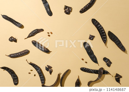 Plenty black locust fruits and seeds scattered flat lay on light brown table, photo was taken with a top-down camera angle. Blank space for displaying or presentation Plenty black locust fruits and seeds scattered flat lay on light brown table, photo was taken with a top-down camera angle. Blank space for displaying or presentation 114148687