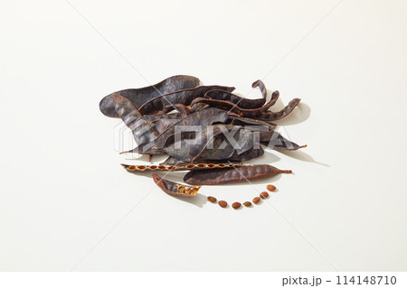A pile of black locust pods isolated on white background from high angle shot. Vacant space for displaying product made from black locust, copy space A pile of black locust pods isolated on white background from high angle shot. Vacant space for displaying product made from black locust, copy space 114148710