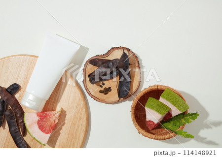 Flat lay natural compositions of cosmetic producing over white table, a white tube without label. Blank space for advertising and designing Flat lay natural compositions of cosmetic producing over white table, a white tube without label. Blank space for advertising and designing 114148921
