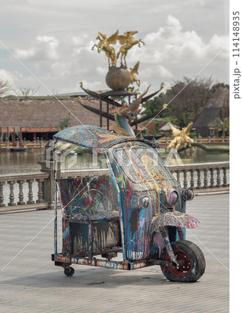 Oil and Acrylic Painted art design on Tuk-Tuk vehicle cut in half parked on the street. Oil and Acrylic Painted art design on Tuk-Tuk vehicle cut in half parked on the street. 114148935