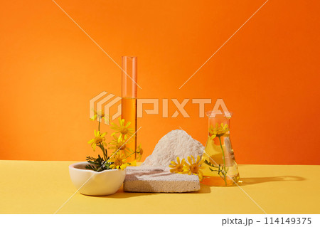 Abstract minimal scene - empty brick podiums decorated with erlenmeyer flask, test tube and fresh calendula flowers on orange background. Space for display cosmetic product and text. Abstract minimal scene - empty brick podiums decorated with erlenmeyer flask, test tube and fresh calendula flowers on orange background. Space for display cosmetic product and text. 114149375
