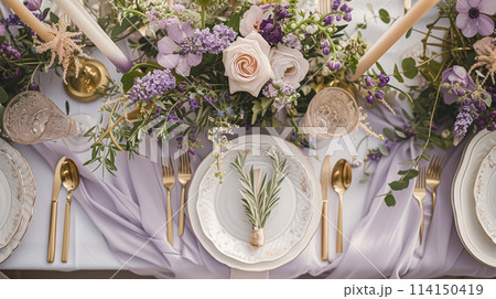 Wedding table decoration with lavender flowers, sweets, cake and candles 114150419