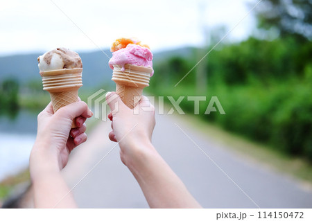 Closed up woman hand holding couple Waffle strawberry and chocolate Ice Cream 114150472