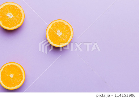 fresh Fruit orange slices on colored background. Top view. Copy Space. creative summer concept. Half of citrus in minimal flat lay with copy space 114153906