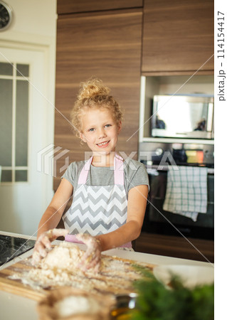 little girl kneading dough, baking cookies for christmas little girl kneading dough, baking cookies for christmas 114154417