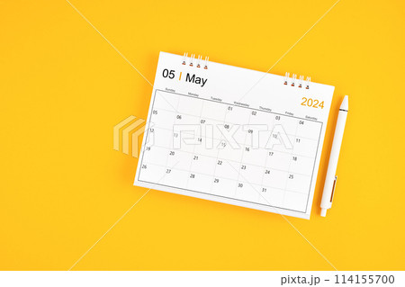 May 2024, Monthly desk calendar for 2024 year and pen on yellow background. 114155700