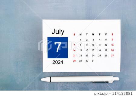 July Calendar 2024 page with pen on wooden background. 114155881