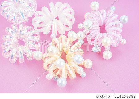 Colorful plastic hair elastics set on beautiful background. Colorful plastic hair elastics set on beautiful background. 114155888