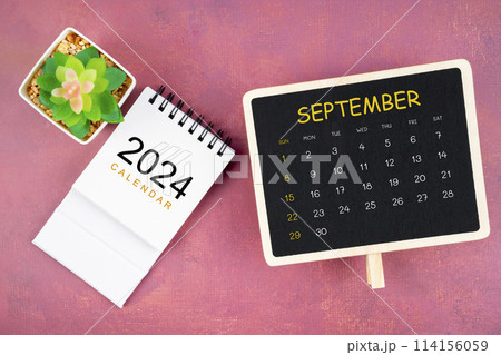Calendar for September 2024 in black chalkboard on red background. 114156059