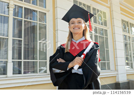 A young girl, a university graduate, in a robe. 114156539