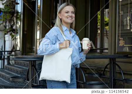 Beautiful girl with coffee on the street. Beautiful girl with coffee on the street. 114156542