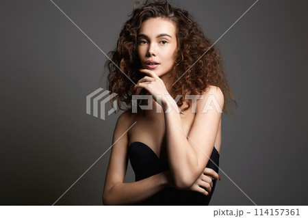 beautiful young woman with curly hair. pretty sexy girl 114157361