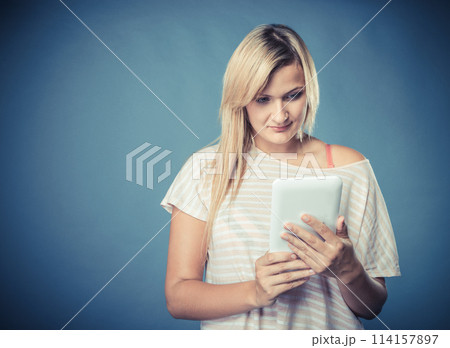 Young woman with tablet on blue 114157897