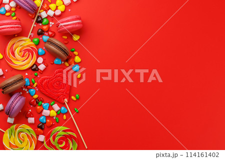 Various colorful candies, lollipops, and macaroons 114161402