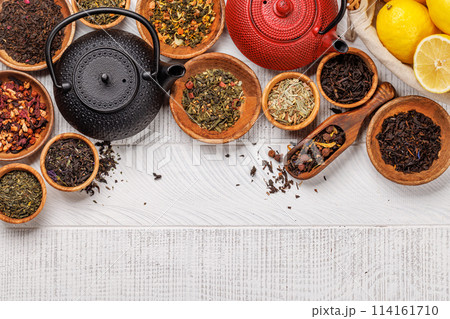A collection of various teas nestled in wooden bowls A collection of various teas nestled in wooden bowls 114161710