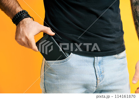 Closeup man take out mobile phone of his pocket 114161870
