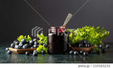 Blueberry jam and fresh berries with leaves. 114163232