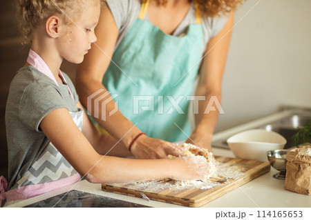 cooking and home concept - close up of female hands kneading dough at home 114165653