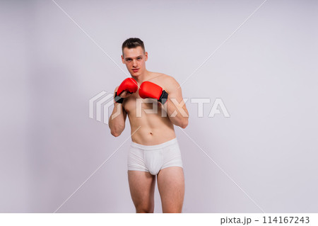 Studio shot of athlete boxer training. Concept of sport, healthy lifestyle. Red sportswear. Studio shot of athlete boxer training. Concept of sport, healthy lifestyle. Red sportswear. 114167243